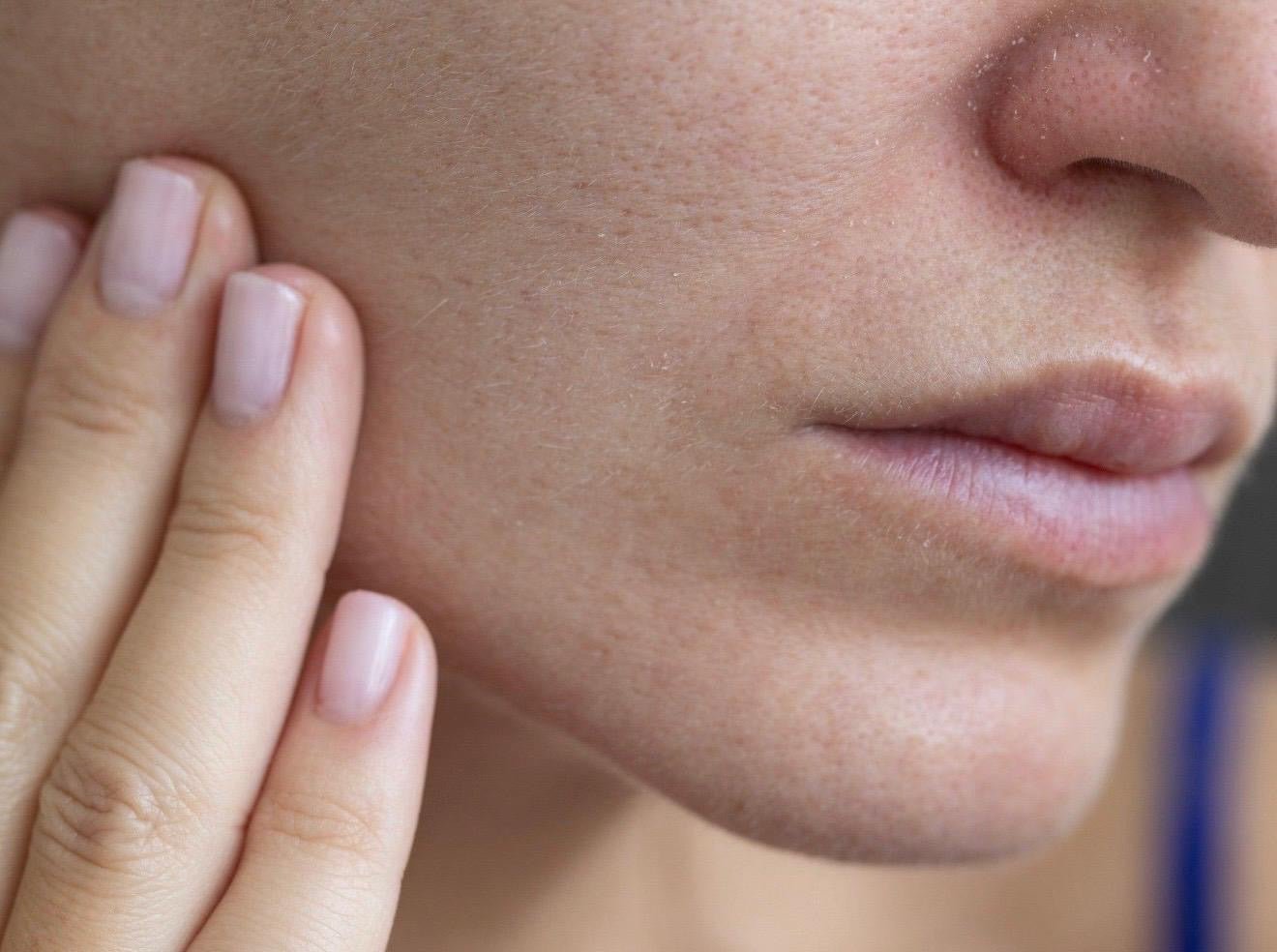 Woman touching her cheek