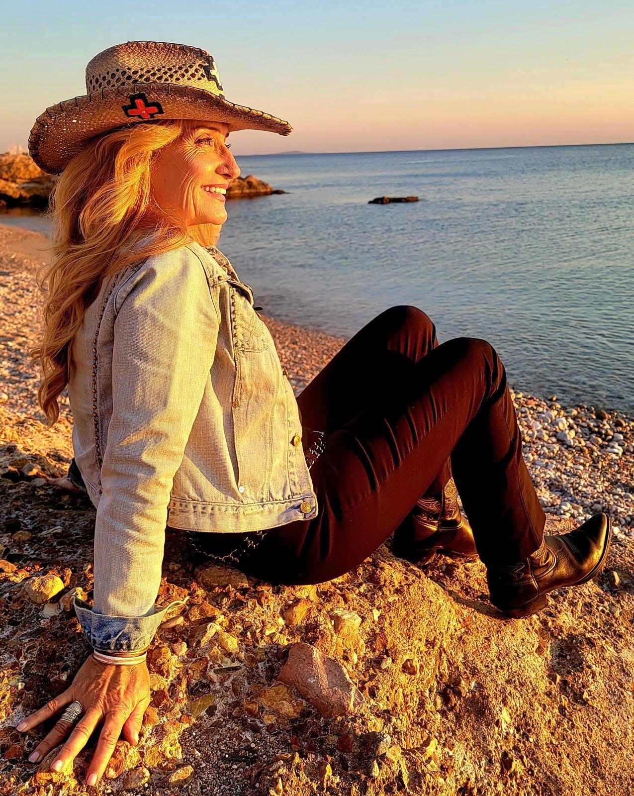 Vicky DeRosa sitting peacefully beside the sea
