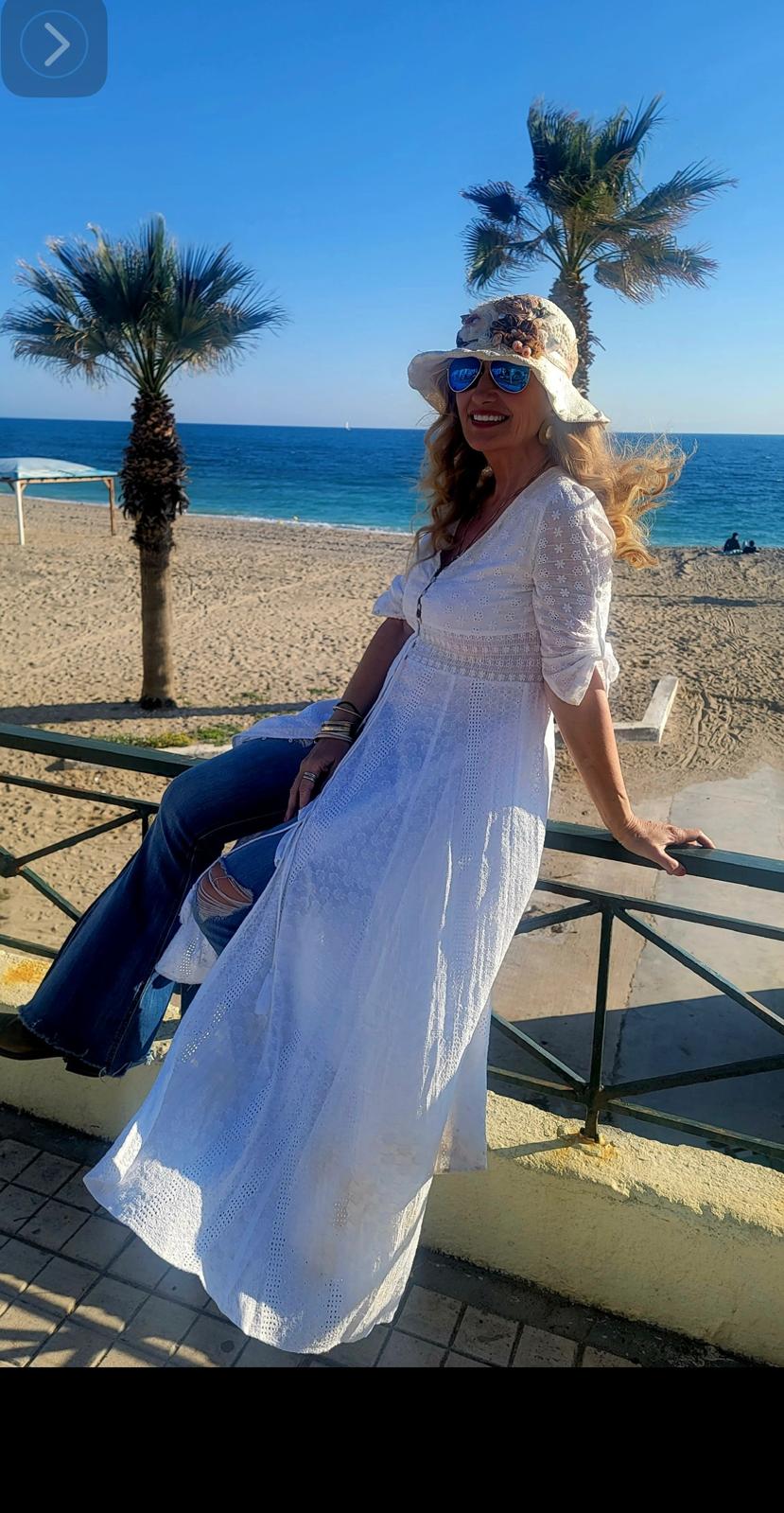 Vicky DeRosa sitting peacefully beside the sea